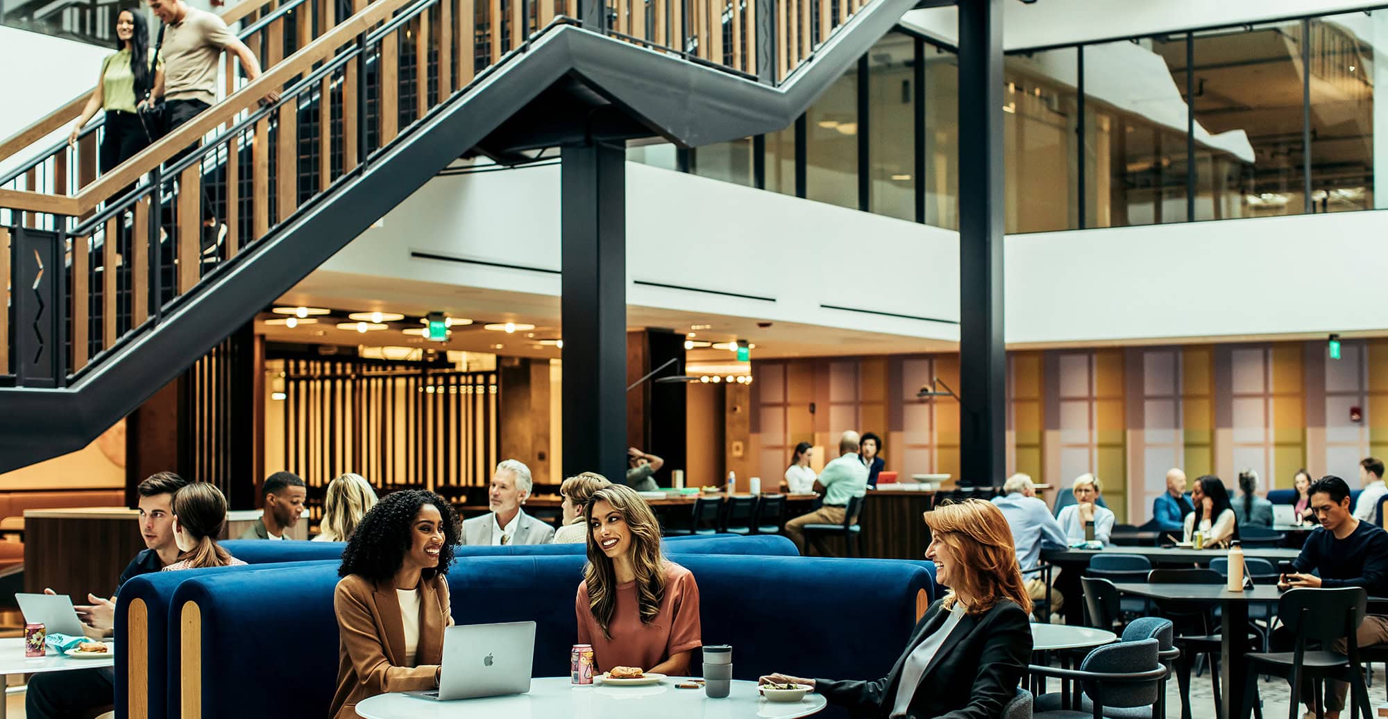 Modern interior space with people working and socializing in a stylish café setting