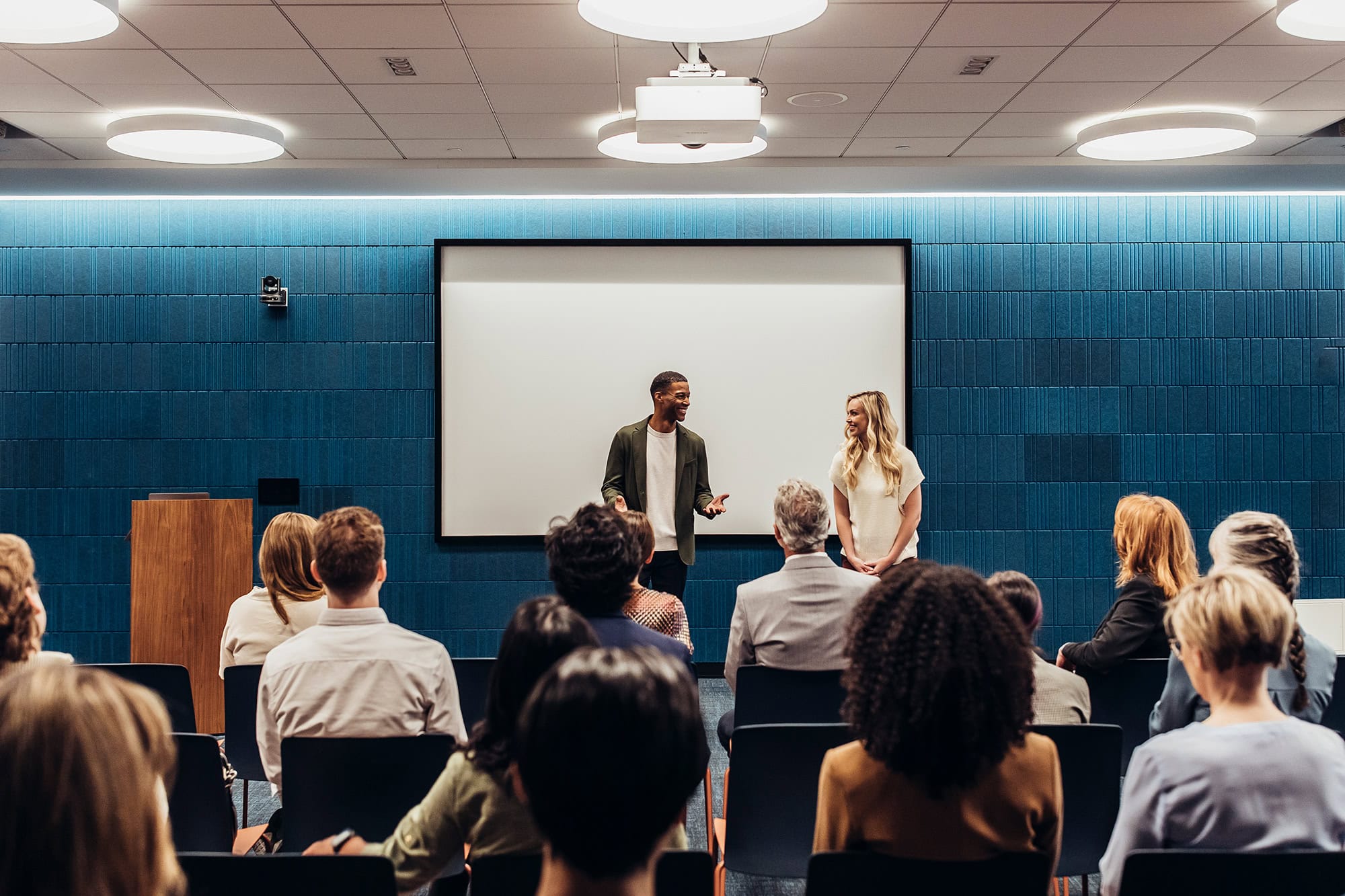 Modern conference facility with speakers engaging a professional audience