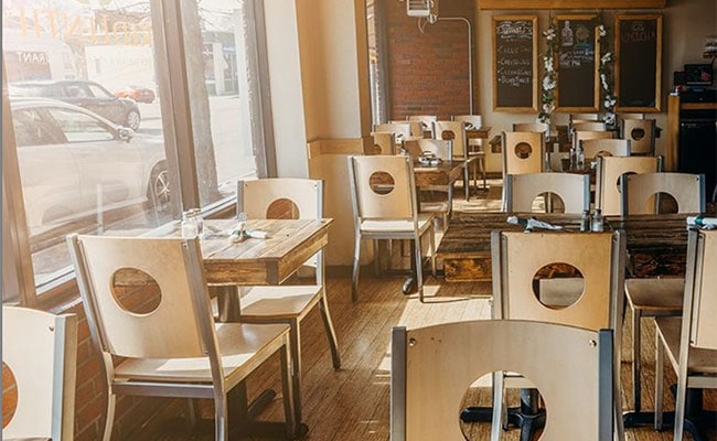 Cozy interior of Red Lentil Vegetarian and Vegan Restaurant with wooden tables and chairs
