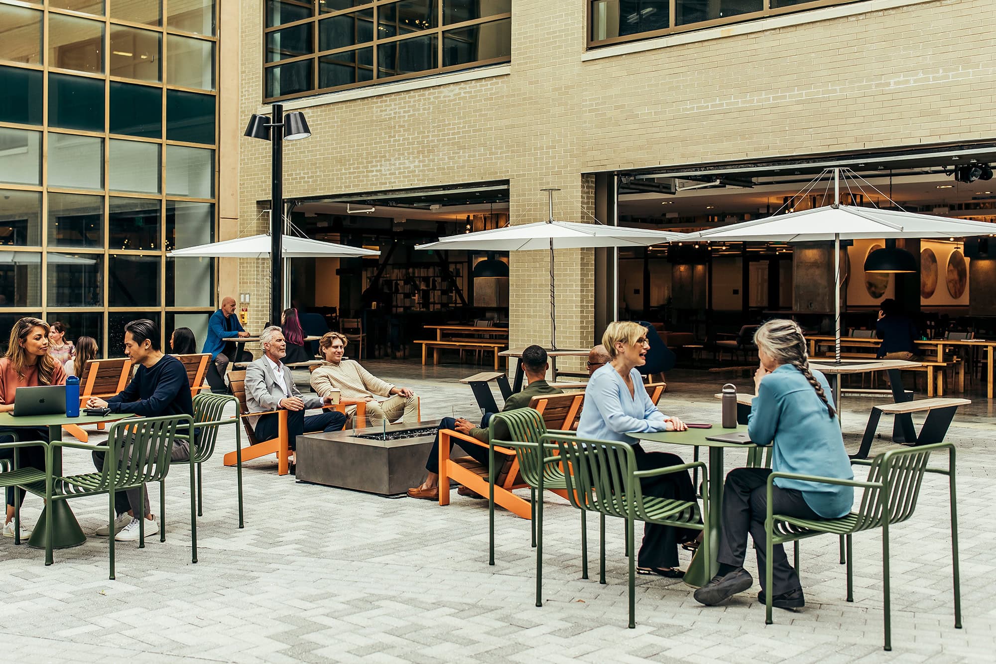 Private courtyard with people enjoying the outdoor seating area and modern patio furniture